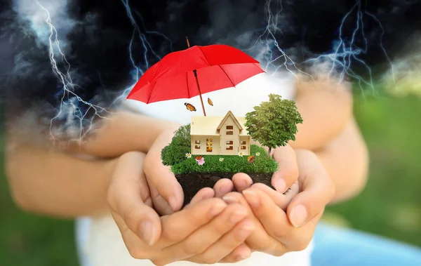 Insurance Concept Umbrella Demonstrating Protection Family Holding House Model Green — Stock Photo, Image