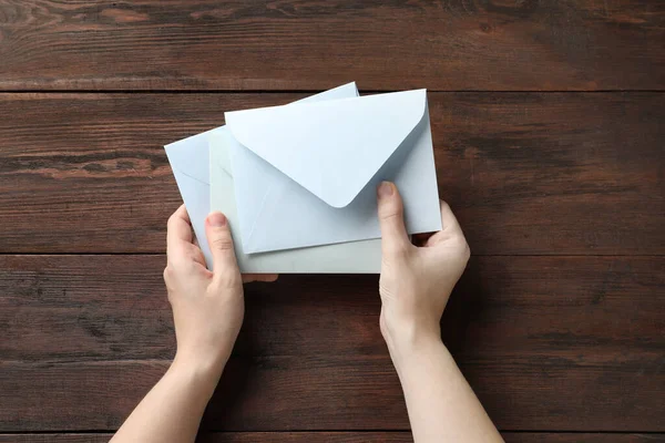 Woman Paper Envelopes Wooden Table Top View — Stock Photo, Image