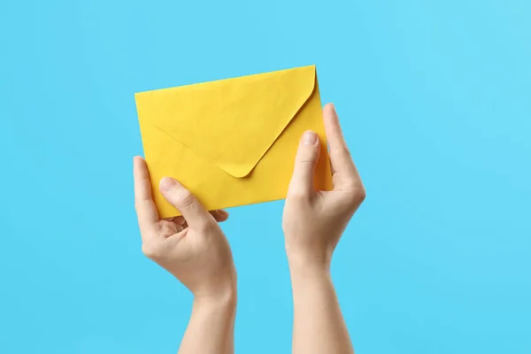 Woman Holding Yellow Paper Envelope Light Blue Background Closeup — Stock Photo, Image