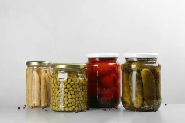 Jars of pickled vegetables on light table