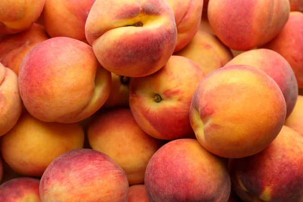 Fresh ripe peaches as background, top view