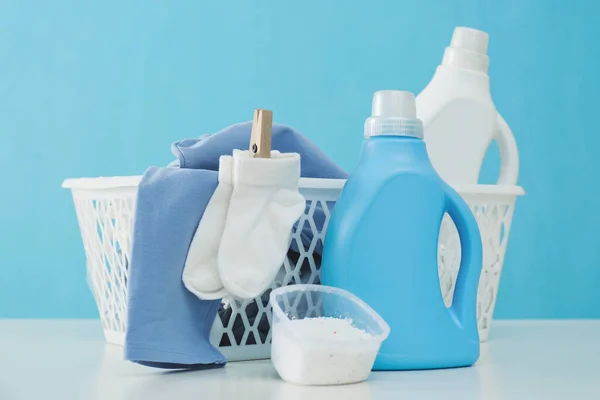 Detergents Children Clothes White Table Light Blue Wall — Stock Photo, Image