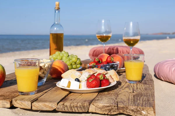 Food and drinks on beach. Summer picnic