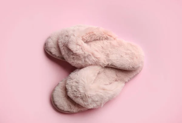 Pair of stylish soft slippers on pink background, flat lay