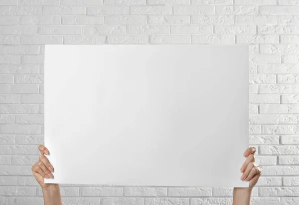 Woman Holding Blank Poster White Brick Wall Closeup Mockup Design — Stock Photo, Image