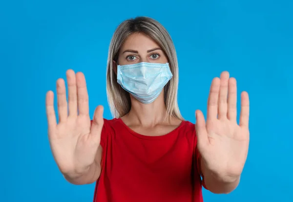 Mulher Máscara Protetora Mostrando Parar Gesto Fundo Azul Claro Prevenir — Fotografia de Stock