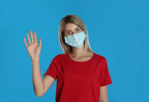 Woman Protective Mask Showing Hello Gesture Light Blue Background Keeping — Stock Photo, Image