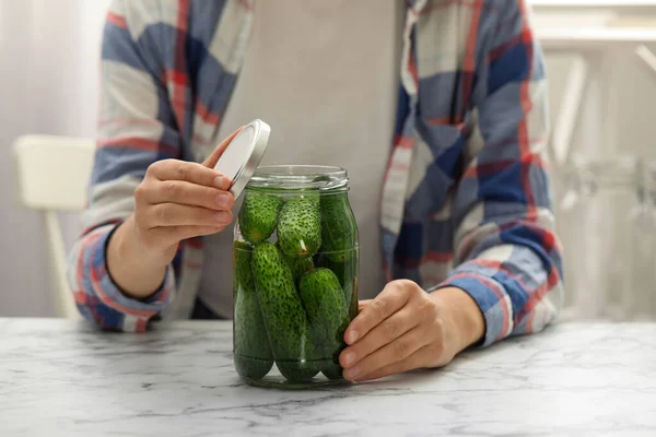 Woman pickling glass jar of cucumbers at white marble kitchen table, closeup — Stock Image Woman Pickling Glass Jar Cucumbers White Marble Kitchen Table Closeup Royalty Free Stock Photos