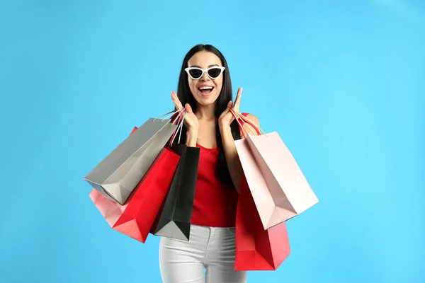 Excited Young Woman Paper Shopping Bags Light Blue Background — Stock Photo, Image