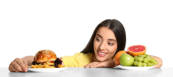 Γυναίκα Επιλέγοντας Ανάμεσα Φρούτα Και Burger Τηγανητές Πατάτες Λευκό Φόντο — Φωτογραφία Αρχείου