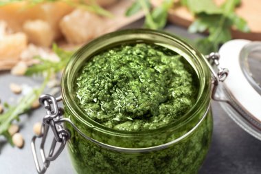 Masada bir kavanoz roka pesto, yakın plan.