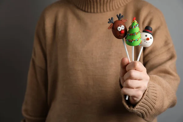 Woman Holding Delicious Christmas Themed Cake Pops Grey Background Closeup — Stock Photo, Image