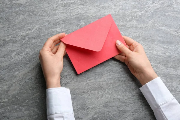 Mulher Segurando Envelope Papel Vermelho Fundo Cinza Close — Fotografia de Stock