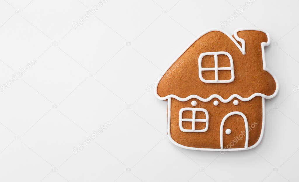 Christmas house shaped gingerbread cookie on white background, top view