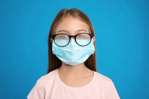 Little Girl Foggy Glasses Caused Wearing Disposable Mask Blue Background — Stock Photo, Image