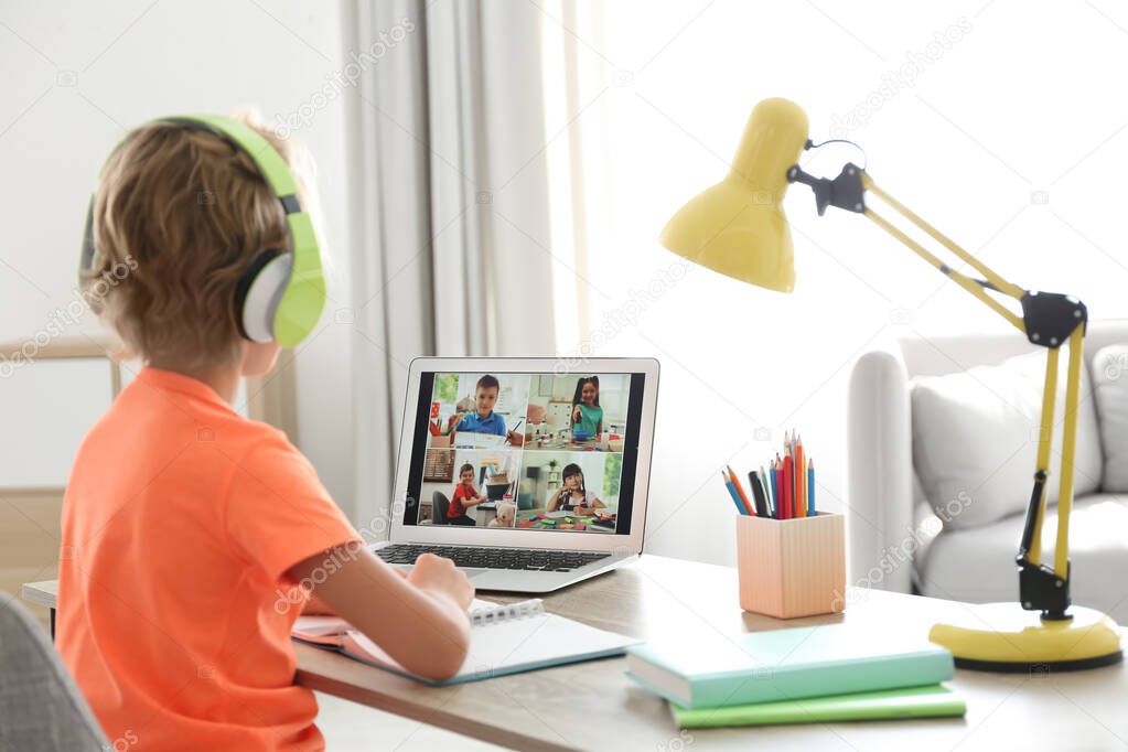 Little boy studying with classmates via video conference at home. Distance learning during COVID-19 pandemic