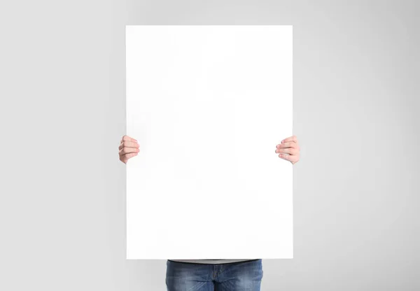 Man Holding Blank Poster Light Grey Background — Stock Photo, Image