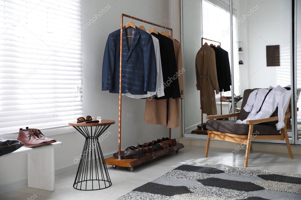 Dressing room interior with clothing rack and armchair