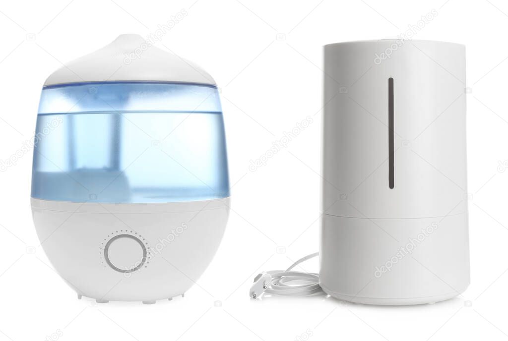 Two modern air humidifiers on white background