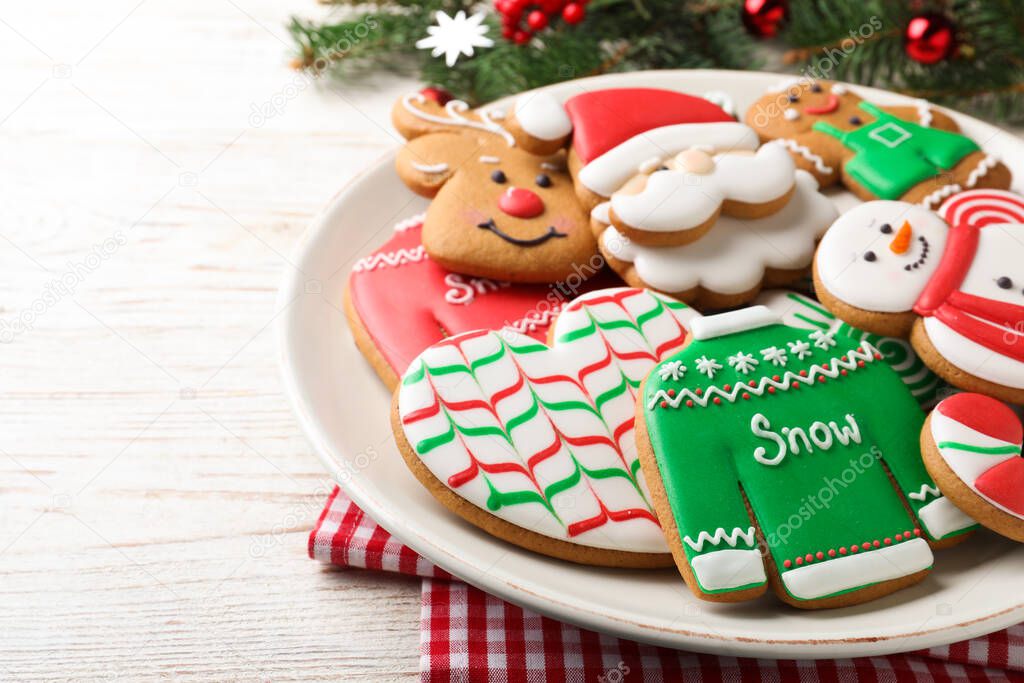 Delicious Christmas cookies on white wooden table, closeup