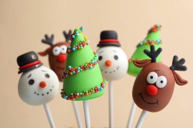 Bej arka planda lezzetli Noel temalı pastalar, yakın plan.