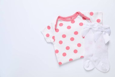 Şık bir bebek tulumu ve beyaz arka planda çorapları var. Metin için boşluk