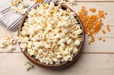 Lezzetli patlamış mısır ve mısır taneleri açık ahşap masada, düz yatıyordu.