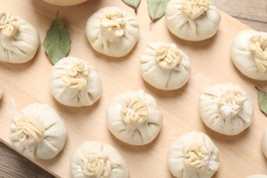 Pişmemiş khinkaliler (hamur tatlısı) ve ahşap masa üzerindeki baharatlar, üst görünüm