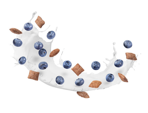 Splashing milk with sweet corn pads and fresh blueberries in air against white background. Healthy breakfast