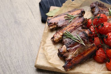 Biberiyeli biftek kaburgası ve ahşap masada domatesler, yakın plan. Metin için boşluk
