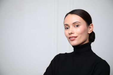 Beyaz duvarın yanında güzel bir kadının portresi. Metin için boşluk