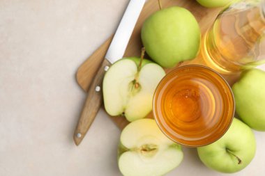 Taze elma şarabı, cam, şişe, elma ve bıçak bej masa, üst manzara. Metin için boşluk