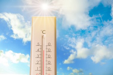 Güneşli bir günde mavi gökyüzüne karşı termometrede yüksek sıcaklık. Yaz havası