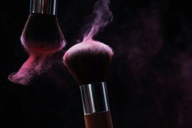 Siyah arkaplanda renk farlı makyaj fırçaları, yakın plan