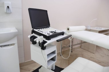 Modern ultrason makinesi ve klinikte muayene yatağı