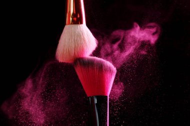 Siyah arka planda pembe göz farlı makyaj fırçaları, yakın plan