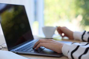 Kahveli kadın masadaki laptopta arka planı bulanık, yakın plan...