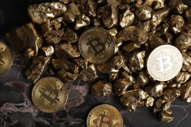 Bitcoinler ve altın külçeler masada, düz yatıyordu.