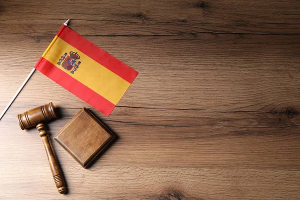 Yargıç tokmağı ve İspanya bayrağı ahşap masanın üstünde, üst manzara. Metin için boşluk