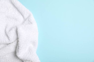 Turkuaz arka planda beyaz havlu, üst manzara. Metin için boşluk