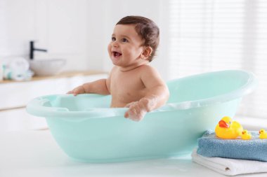 Evde küvette banyo yapan şirin bir bebek.