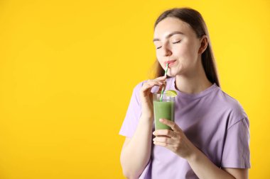 Turuncu arka planda samandan ferahlatıcı içecek içen kadın, mesaj için yer