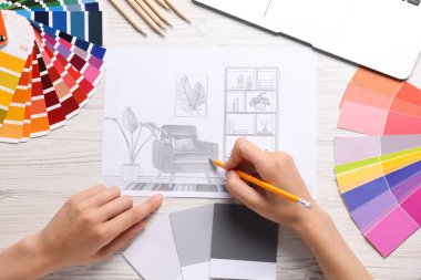 Odanın içini çizen kadın beyaz ahşap masa, üst manzara.