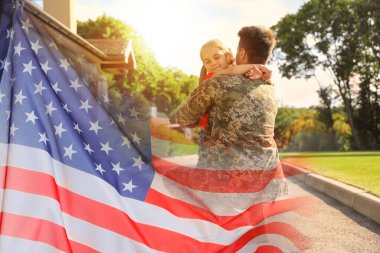 Asker ve kızı açık havada, ABD bayrağıyla çifte gösteri yapıyorlar.