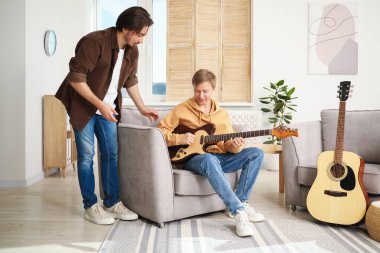 Öğretmenim evde gitar çalmayı öğretiyor.