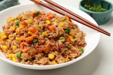 Lezzetli pilav ve çubuklar beyaz masada, yakın plan.