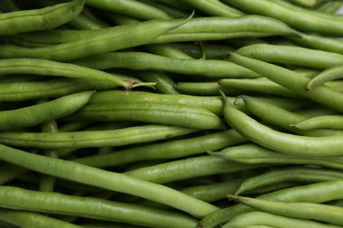 Fresh green bean pods as background, closeup