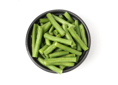 Pieces of fresh green beans in bowl isolated on white, top view