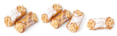 Delicious cannoli with ricotta cheese, peanuts and powdered sugar isolated on white, set. Top view