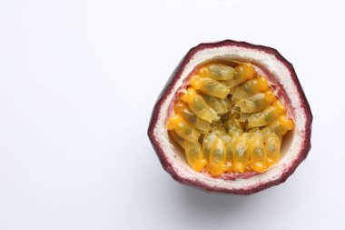 Half of fresh passion fruit on white background, closeup. Space for text
